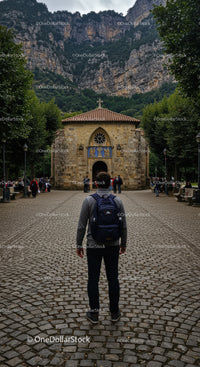 Young traveler exploring historic mountain chapel pathway