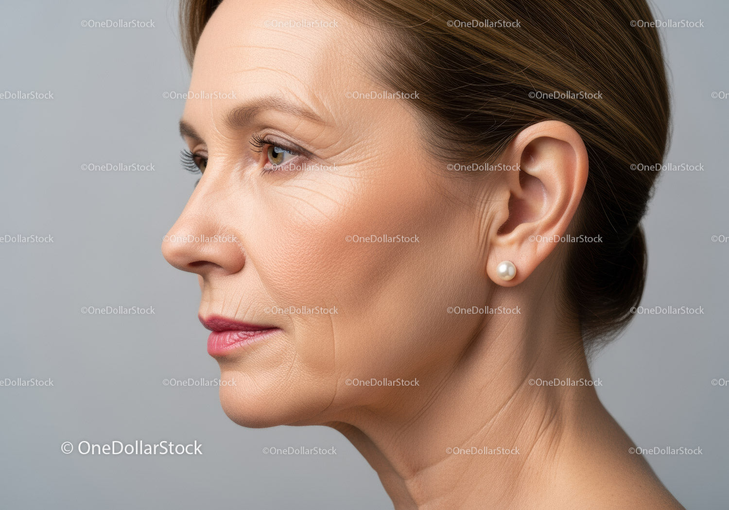 Elegant Woman Side Profile with Pearl Earring in a Glamorous Portrait