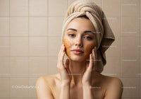 Young Woman Applying Facial Mask with Towel Wrapped Head