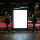 Empty illuminated billboard on city street at night