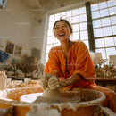Joyful Woman Creating Handmade Pottery in Artistic Studio