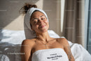 Smiling Woman Relaxing with Towel on Head in Spa or Wellness Center