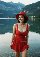 Elegant Woman in Red Dress Smiling by Lake Outdoors
