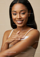 Young Smiling Woman Applying Sunscreen on Shoulder for Healthy Skin