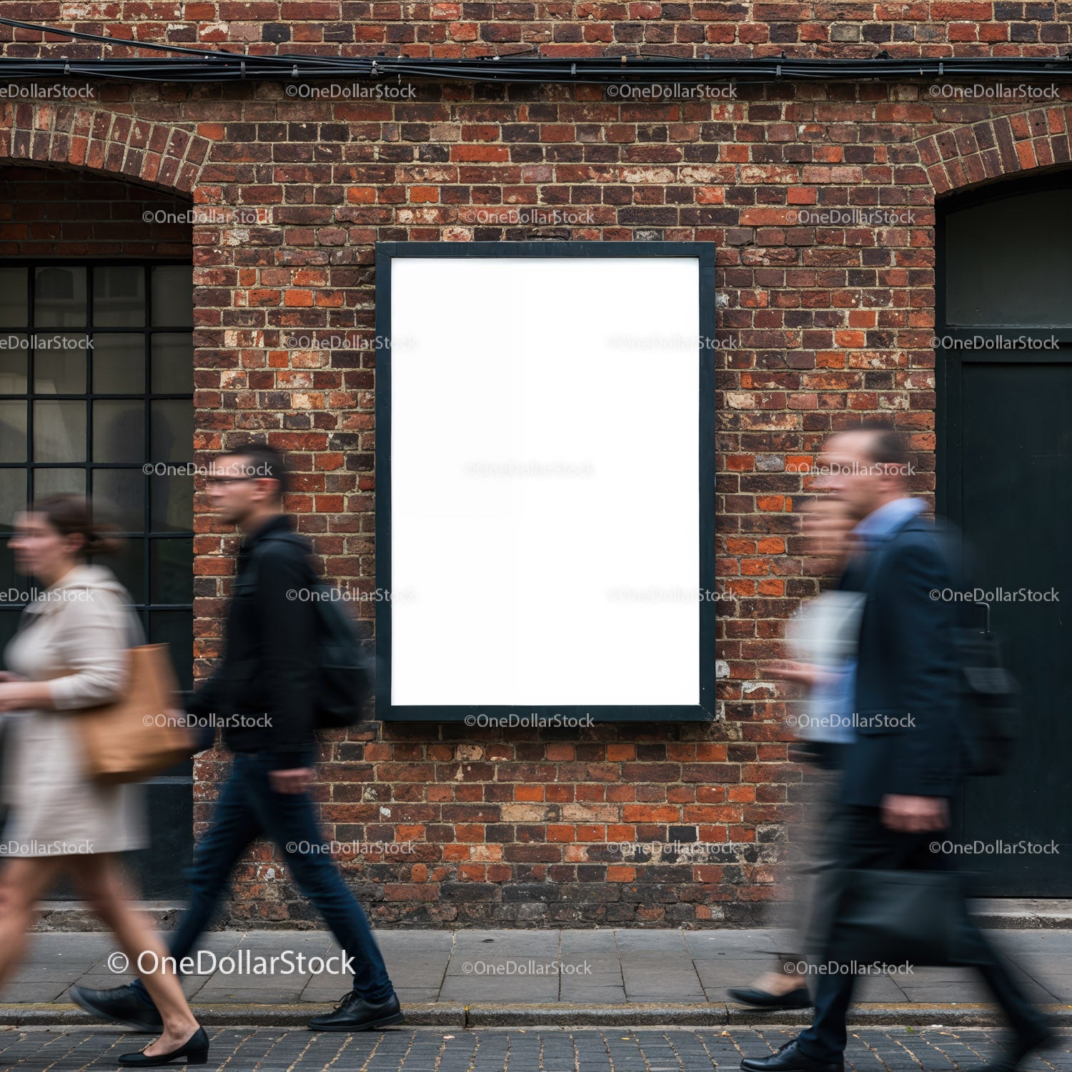 Busy pedestrians passing blank billboard on brick wall