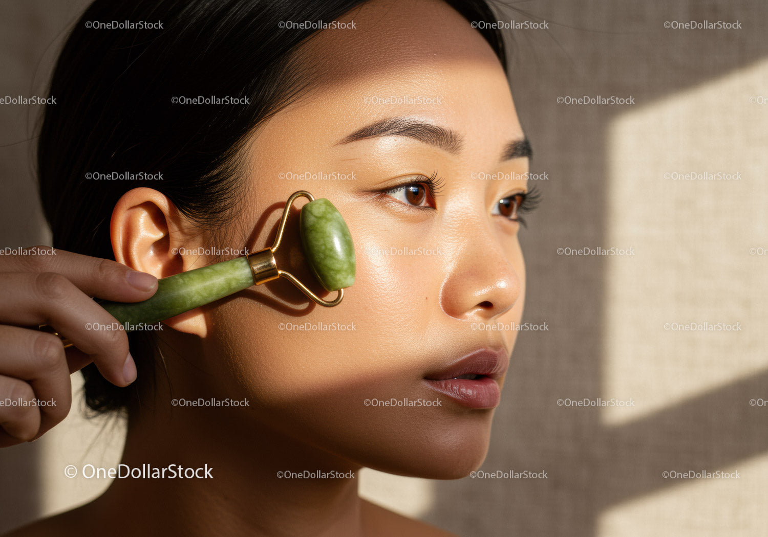 Young Woman Using Jade Roller for Facial Massage and Skin Rejuvenation