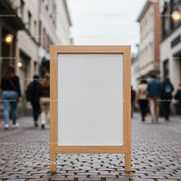 Blank wooden sidewalk sign on urban cobblestone street