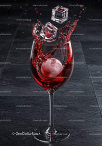 Red Drink Splash with Ice Cubes in Glassware