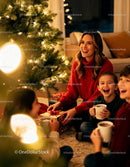 Happy family enjoying Christmas gifts by tree