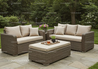 Elegant Wicker Garden Sofa Set with Cushions in Lush Backyard