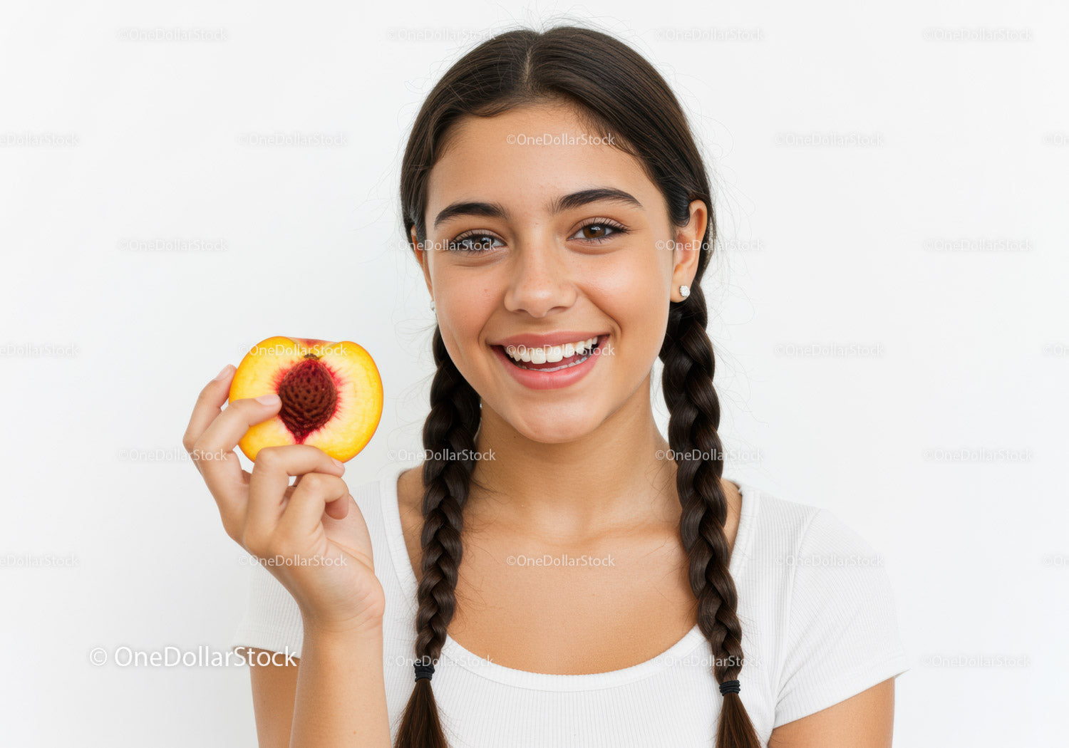 Young Woman Holding Peach Slice with Bright Smile in Studio
