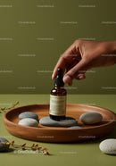 Essential Oil Dropper Bottle on Wooden Tray with Stones