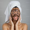 Woman with Brown Face Mask and Towel on Head in Spa Environment
