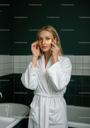 Woman Applying Gold Under Eye Patches for Skin Rejuvenation