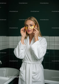 Woman Applying Gold Under Eye Patches for Skin Rejuvenation