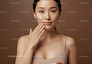 Young Woman Applying Cream with Beautiful Skin and Brown Background