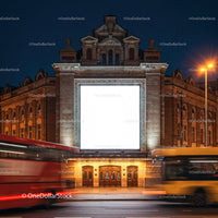 Historic building facade with illuminated billboard at night