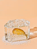 Frozen Lemon Slice Embodied in Clear Ice Block