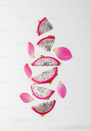 Fresh Dragon Fruit Slices with Pink Petals on White