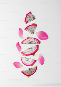 Fresh Dragon Fruit Slices with Pink Petals on White