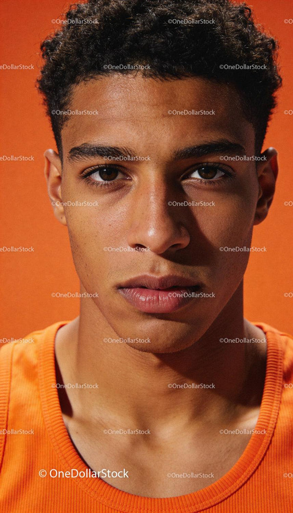 Focused young athlete in vibrant orange sportswear