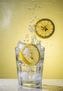 Refreshing Lemon Slices Splashing in Icy Water Glass