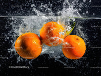 Fresh Orange Fruits Splashing into Water with Vibrant Colors