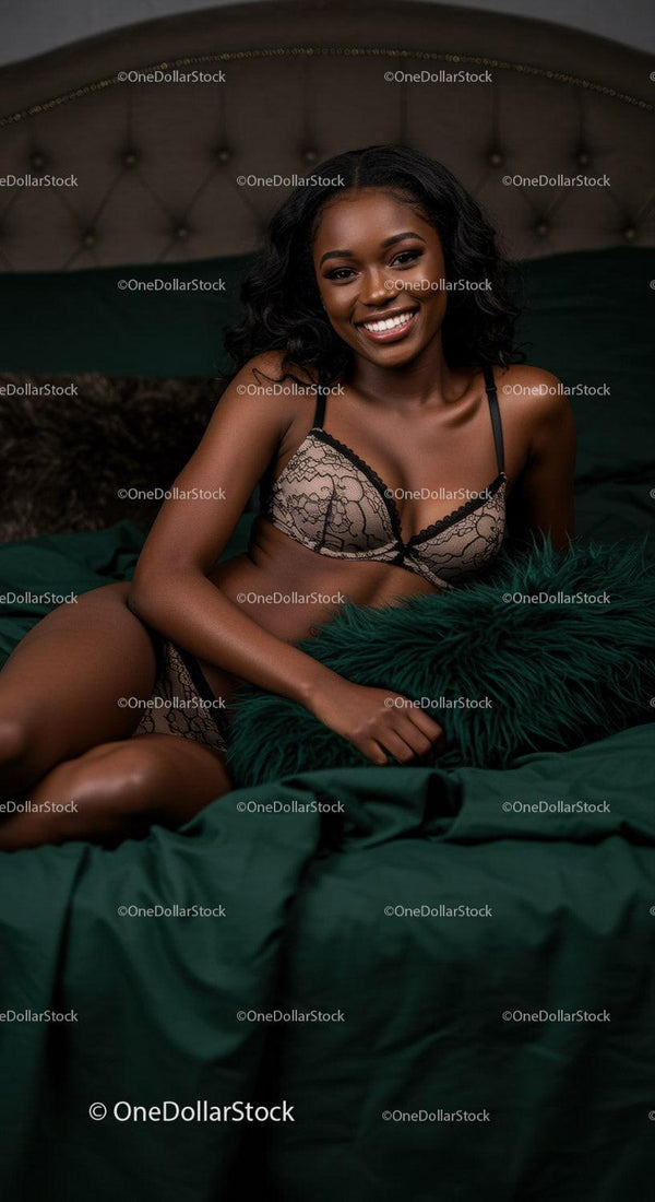 Smiling woman relaxing on bed in elegant lingerie