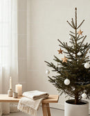 Minimalist Christmas tree with decorations in cozy room