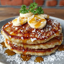 Stack of Fluffy Pancakes with Bananas and Caramel Sauce