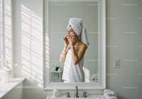 Young Woman in Bathroom Towel Applying Skincare Routine