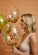 Smiling woman celebrating first birthday with golden balloons