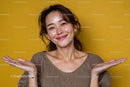 Confident Smiling Woman with Wavy Hair in Brown Top on Yellow Background