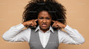 Frustrated Woman Covers Ears Against Noise in Business Attire