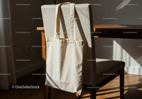 Natural Canvas Tote Bag Hanging on Chair in Sunlight