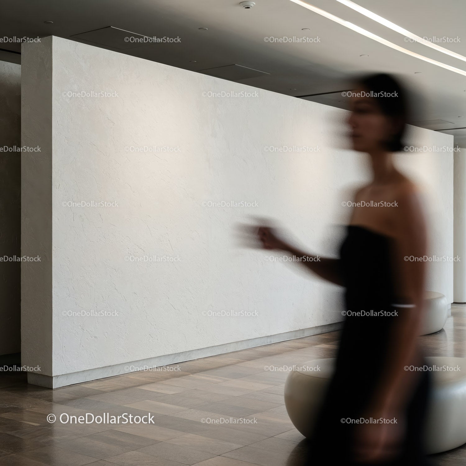 Blurred silhouette of woman walking in modern interior