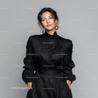 Elegant Woman in Black Dress with Statement Earrings in Studio