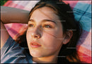 Young woman resting outdoors in warm sunlight