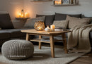 Cozy living room with warm candlelight and knit accents