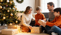 Family Unwrapping Christmas Gifts Together Indoors