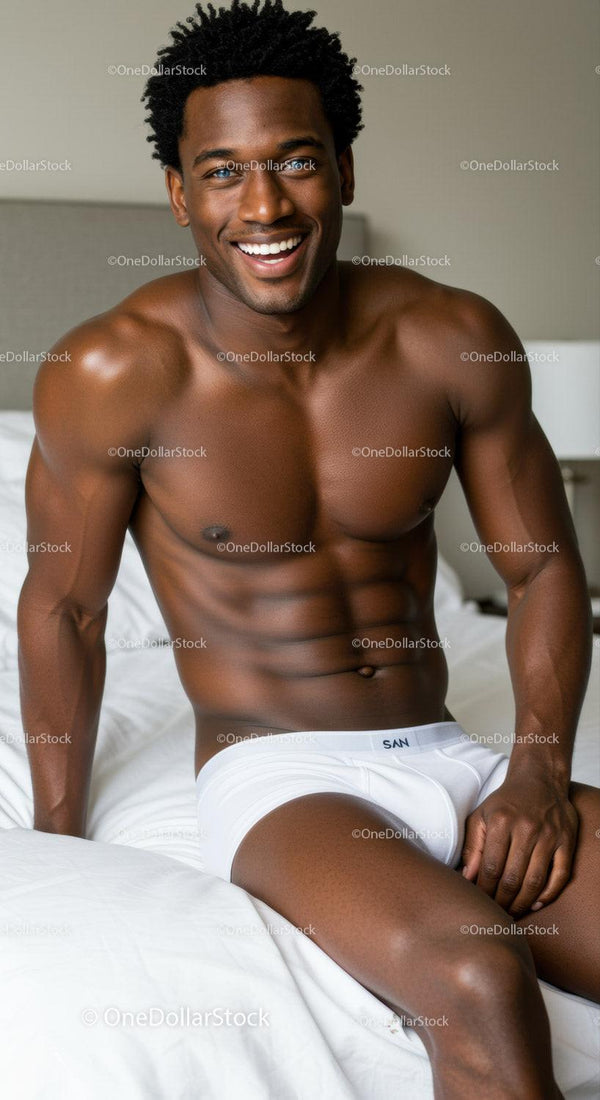 Smiling muscular man relaxing on bed in white underwear