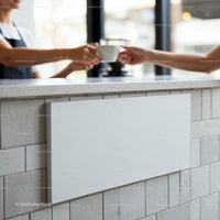 Barista hands coffee cup to customer over counter