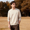 Young man standing thoughtfully in autumn park