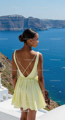 Woman in yellow dress overlooking serene seaside cliffs