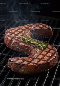 Juicy grilled steak with fresh rosemary garnish