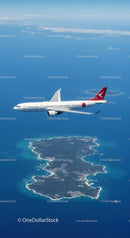 Commercial Jet Flying Over Tropical Ocean With Island Below