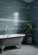 Elegant vintage bathtub with green indoor plant in blue bathroom