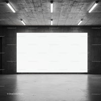 Empty industrial space with large illuminated wall panel