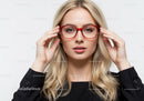 Fashionable Blonde Woman Wearing Red Glasses in Studio Portrait