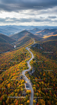 Majestic Mountain Landscape with Winding Road and Vibrant Fall Foliage